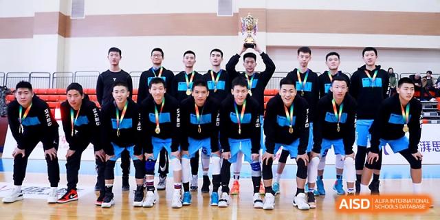 A triumphant male basketball team in black and blue uniforms poses with their championship trophy and medals at The High School Affiliated to Xi_an Jiaotong University.