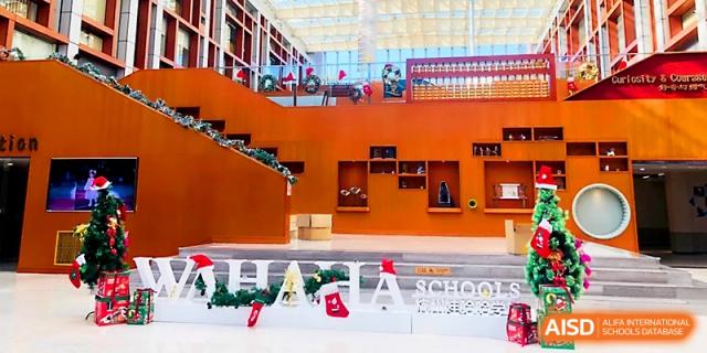 The school's grand wooden staircase and atrium are decorated for a special event at Wahaha International School.