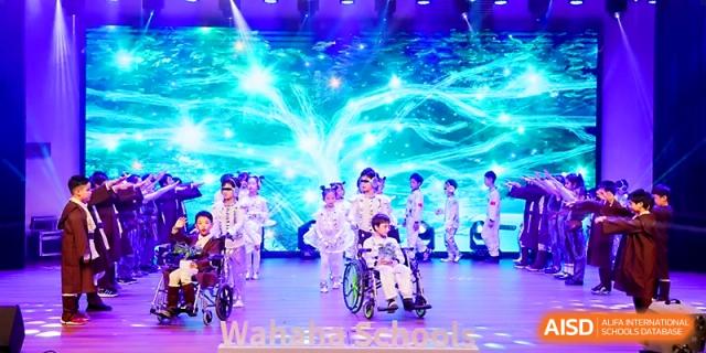 Students perform a futuristic-themed dance routine with bright blue visual effects at Wahaha International School.
