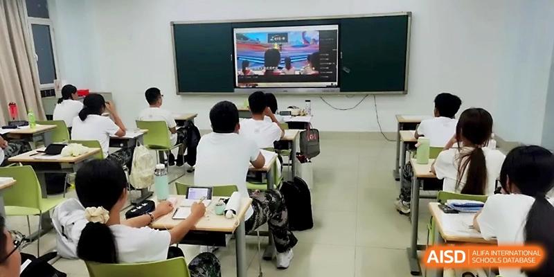 Students are seated in a modern classroom, actively taking notes while a presentation is displayed on the front screen at WeiFang No.1 Middle School.