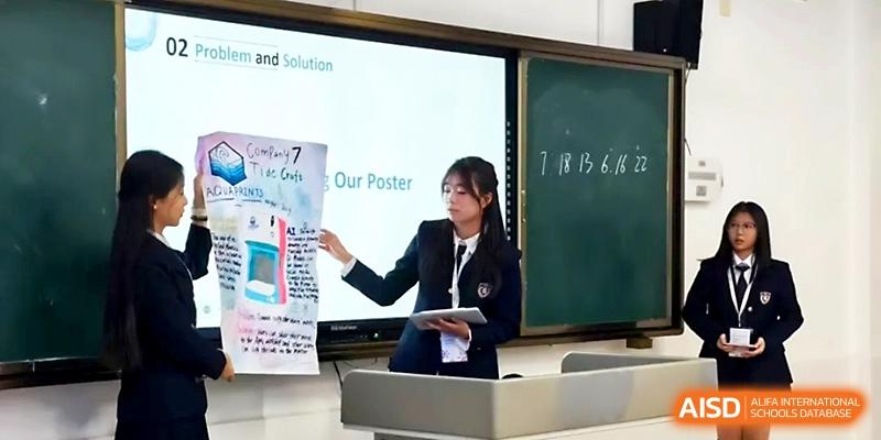 A female student in a blazer stands at the front of a classroom presenting a research poster to her peers at WeiFang No.1 Middle School.