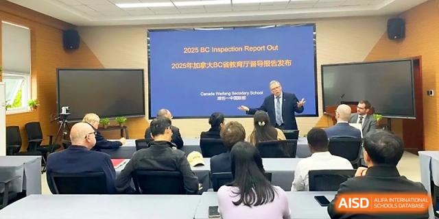 An audience of students and staff listen to a presenter during the 2025 BC Inspection Report meeting at WeiFang No.1 Middle School.