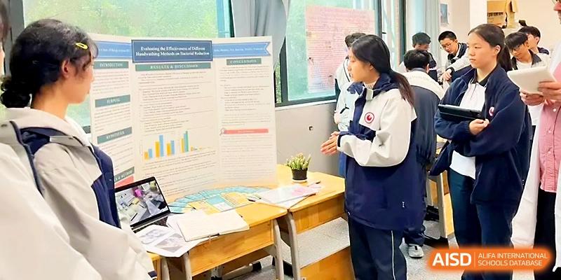 A student presents a detailed science fair project using a tri-fold board and data charts in a classroom at Wuhan No.2 High School.