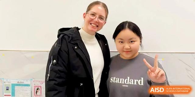 A female teacher and a student smile for a portrait together, reflecting the supportive mentorship found at Wuhan No.2 High School.