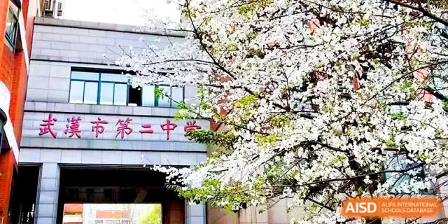 Beautiful cherry blossoms bloom in front of the traditional school gate at Wuhan No.2 High School.