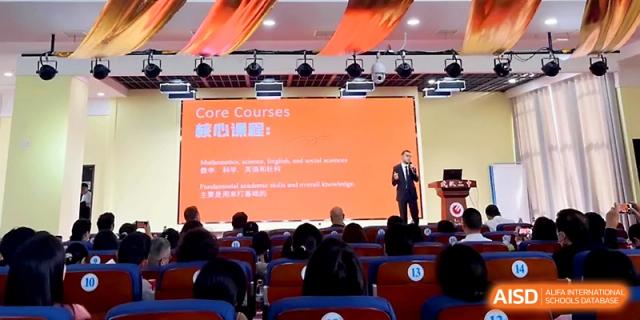 An educator presents "Core Courses" to a large audience of parents and students at Wuhan No.2 High School.