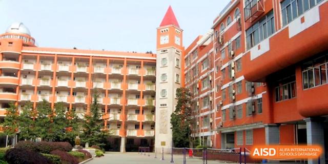 The impressive clock tower stands tall against the bright sky on the campus of Wuhan No.2 High School.