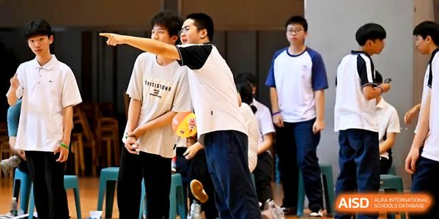 A student prepares to throw a ball during a competitive game in the school gymnasium at Wuhan No.2 High School.