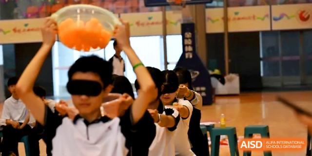 Students cheer enthusiastically from the sidelines during an indoor sports event at Wuhan No.2 High School.