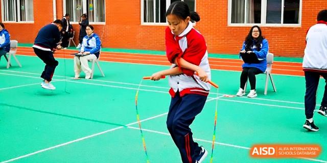 A student demonstrates their jump rope skills during an outdoor sports and cultural festival at Xi_an Bodi School.
