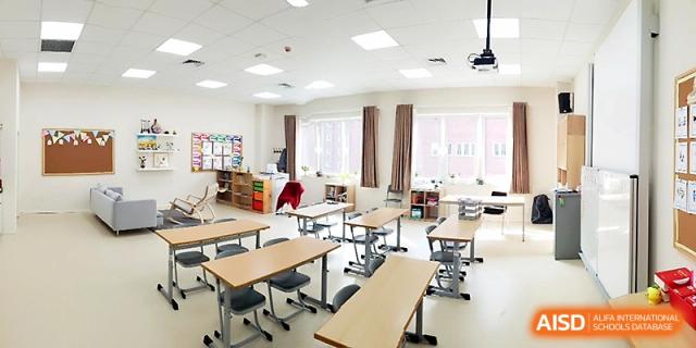 A bright and organized elementary classroom with modern desks and chairs ready for students at Xi_an Hanova International School.