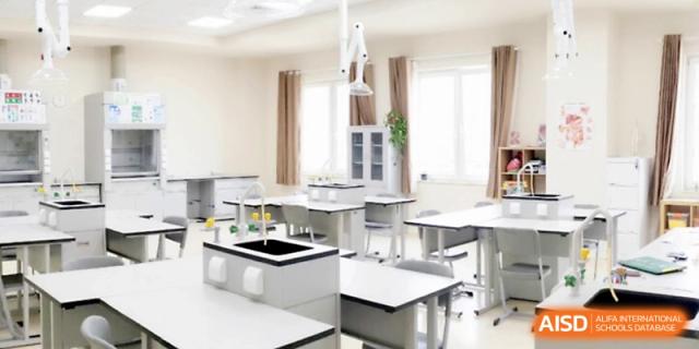 A clean and modern science laboratory equipped with workstations and stools for experiments at Xi_an Hanova International School.