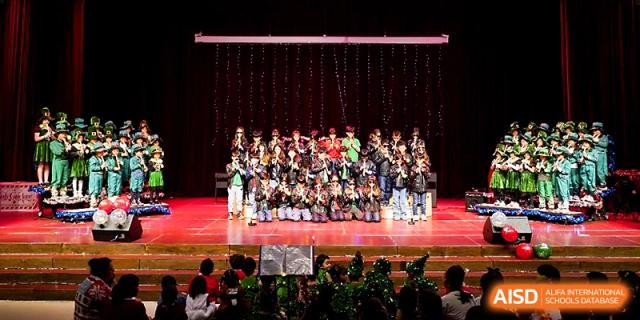 A large choir of students performs a song together on stage during a grand school production at Xi_an Hanova International School.