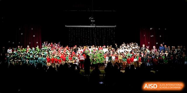 A massive group of students and performers fills the stage for a dramatic finale during a school show at Xi_an Hanova International School.
