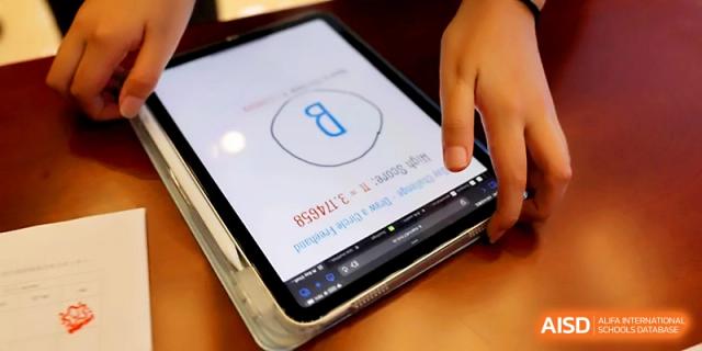 A close-up of a student’s hands using a stylus to work on a tablet-based educational app at Beijing Xicheng Academy.