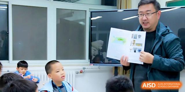 A student looks at a digital screen showing educational content during a modern tech lesson at Yangjiang Yangdong Eone school.