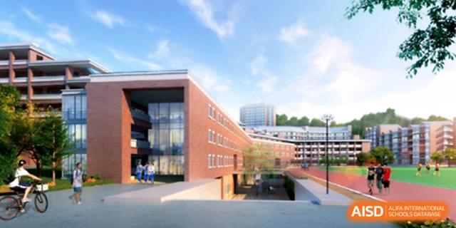 A wide architectural view of the modern red brick campus buildings and open walkways under a clear blue sky at Yangjiang Yangdong Eone school.