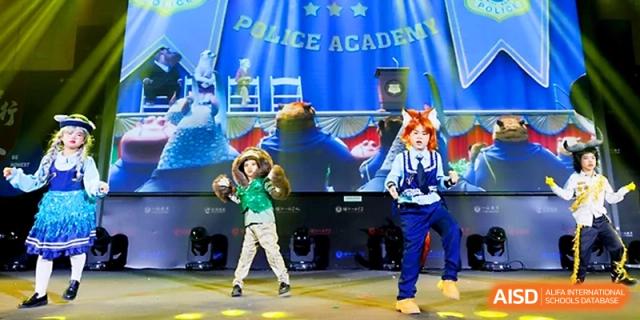 Performers in colorful costumes take the stage for a "Police Academy" themed theatrical production at Yangjiang Yangdong Eone school.