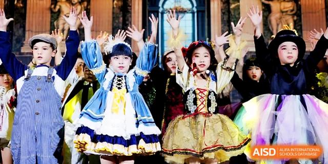 Young girls in ornate, traditional dresses perform a choreographed dance during a cultural arts festival at Yangjiang Yangdong Eone school.