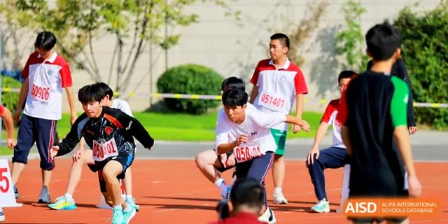 Students at the starting line prepare to begin a race during a competitive track and field meet at Yangzhou Shuren High School.
