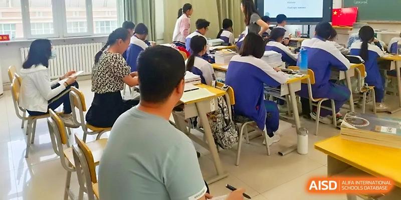 Students sit at their desks in a bright, organized classroom during an interactive morning lecture at Yinchuan No.1 High School.