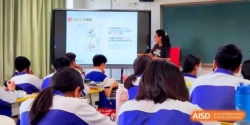 An instructor uses a large touchscreen monitor to explain complex concepts to an attentive class at Yinchuan No.1 High School.