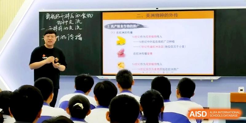 A digital display at the front of a classroom shows a lesson about food and history to a group of students at Yinchuan No.1 High School.