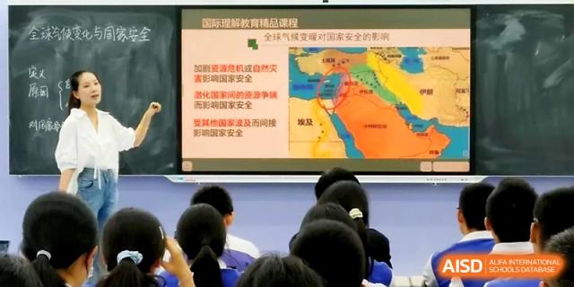 A classroom presentation displays a map and educational text on a large monitor for students at Yinchuan No.1 High School.