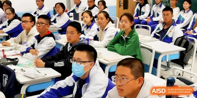 A group of students wearing glasses sits at their desks, looking forward with concentration during a lecture at Yinchuan No.1 High School.