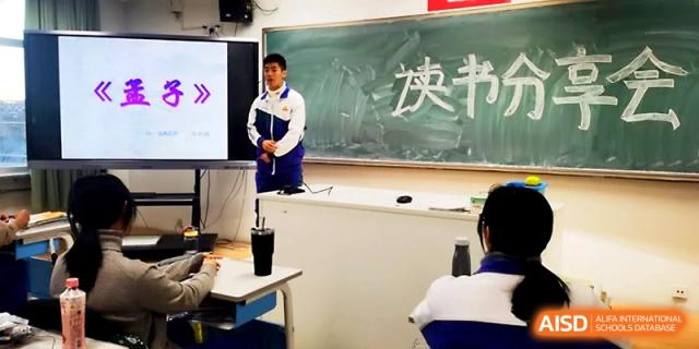 A student stands confidently at the front of the class to deliver a speech next to the chalkboard at Yinchuan No.1 High School.