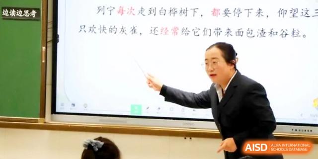 A teacher uses a pointer to highlight specific Chinese text on a bright interactive screen at Zhangjiagang IVY Experimental School.