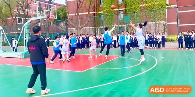 Students play an active game of basketball on the school's colorful outdoor court at Zhangjiagang IVY Experimental School.