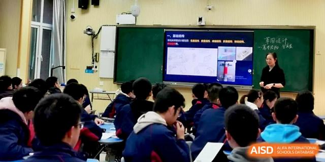 A classroom screen displays a world map and data points during a geography or social studies lecture at Zhejiang ZhouShan High School.
