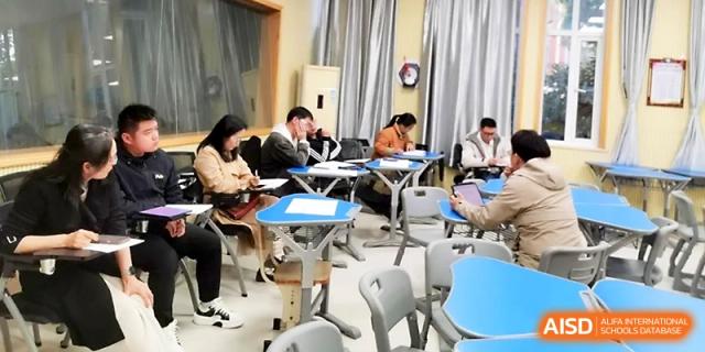 Students work in small groups at hexagonal tables, promoting a collaborative and interactive environment at Zhejiang ZhouShan High School.