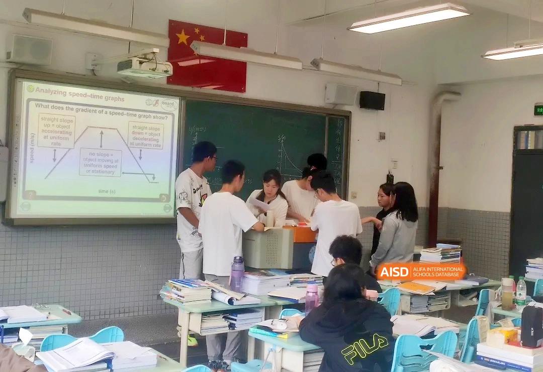 Students gather around a desk to collaborate on a hands-on project in a vibrant and interactive classroom setting at Zhengzhou No.1 High School