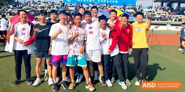 A group of male students celebrates and poses together after participating in various track and field events at Zhengzhou No.1 High School