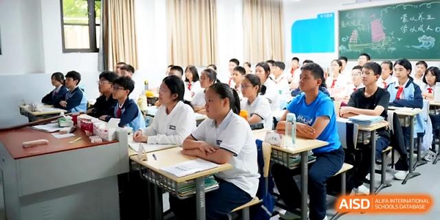A row of students sits at their desks in a modern classroom during an interactive learning session at Zhengzhou No.1&8 United International School