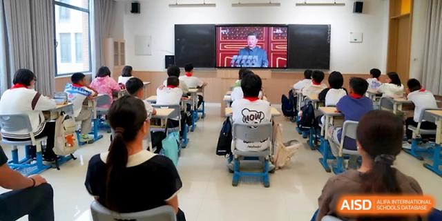 A view from the back of a classroom showing students focused on a digital presentation displayed at the front at Zhengzhou No.1&8 United International School