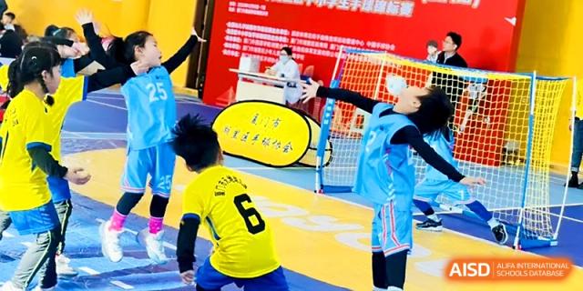 A young soccer player in a yellow jersey dribbles the ball during a fast-paced game at Zhengzhou No.1&8 United International School