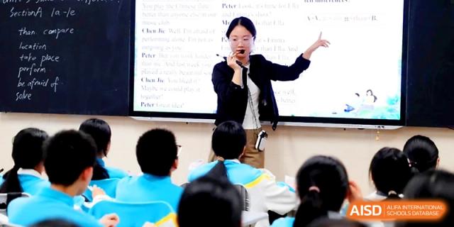 A teacher pointing to a whiteboard while instructing a class at Zhengzhou No.4 Middle School.