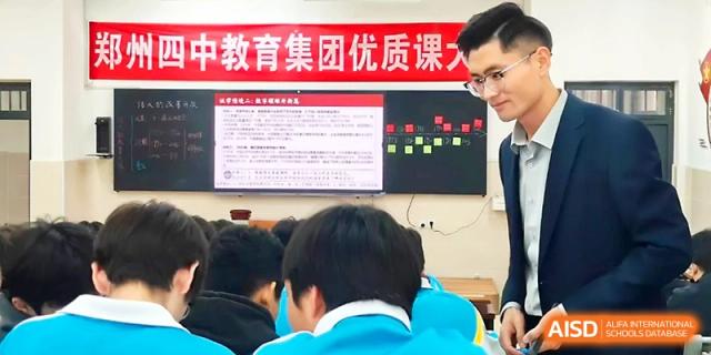 Staff observing a digital presentation during a quality education forum at Zhengzhou No.4 Middle School.
