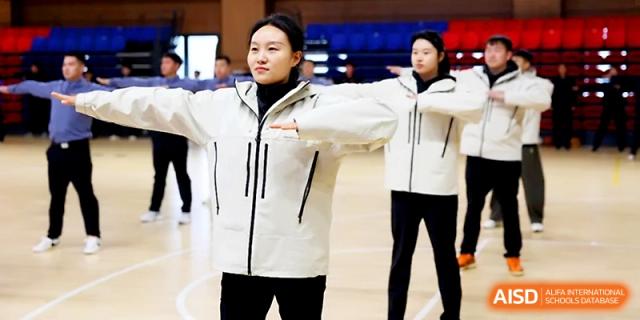 Students in white athletic jackets perform synchronized arm movements during an outdoor assembly at Zhengzhou No.4 Middle School.