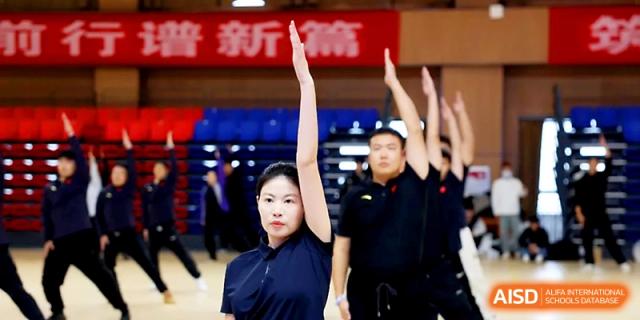 Students in dark blue athletic wear participate in a synchronized physical education drill at Zhengzhou No.4 Middle School.