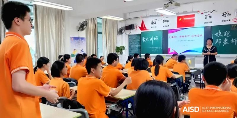Rows of students in orange shirts are seen from behind during a lecture at the Affiliated High School of Fujian Normal University.