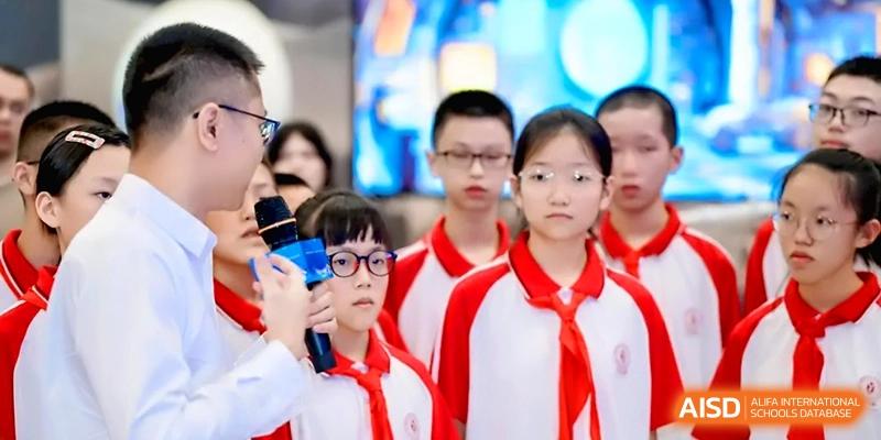 A close-up of students in red and white uniforms listening to a presentation at the Affiliated High School of Fujian Normal University.