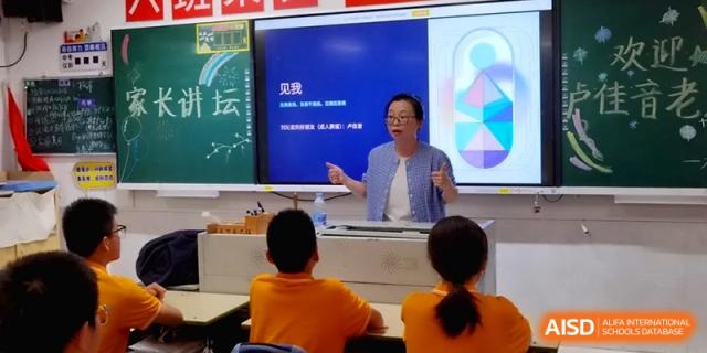 A female teacher gestures while speaking to her students in a bright classroom at the Affiliated High School of Fujian Normal University.