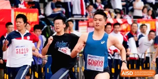 A young man competes in a track and field sprint event during a sports meet at the Affiliated High School of Fujian Normal University.