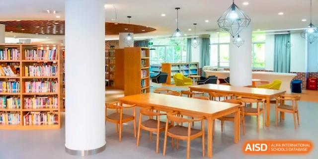 A clean, modern library space with wooden tables and bright windows at the Affiliated High School of Fujian Normal University.