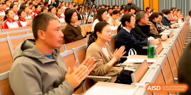 An audience of parents and teachers applauds during a school presentation at the Affiliated High School of Fujian Normal University.