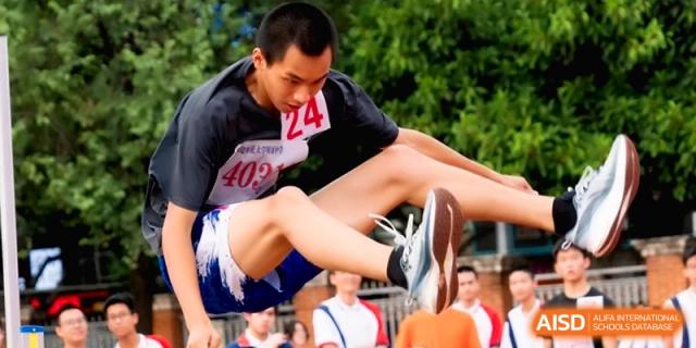 A student athlete jumps over a high bar during a track and field event at the Affiliated High School of Fujian Normal University.